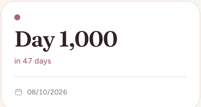 A milestone card in the app reading Day 1,000, in 47 days, on 08/10/2026